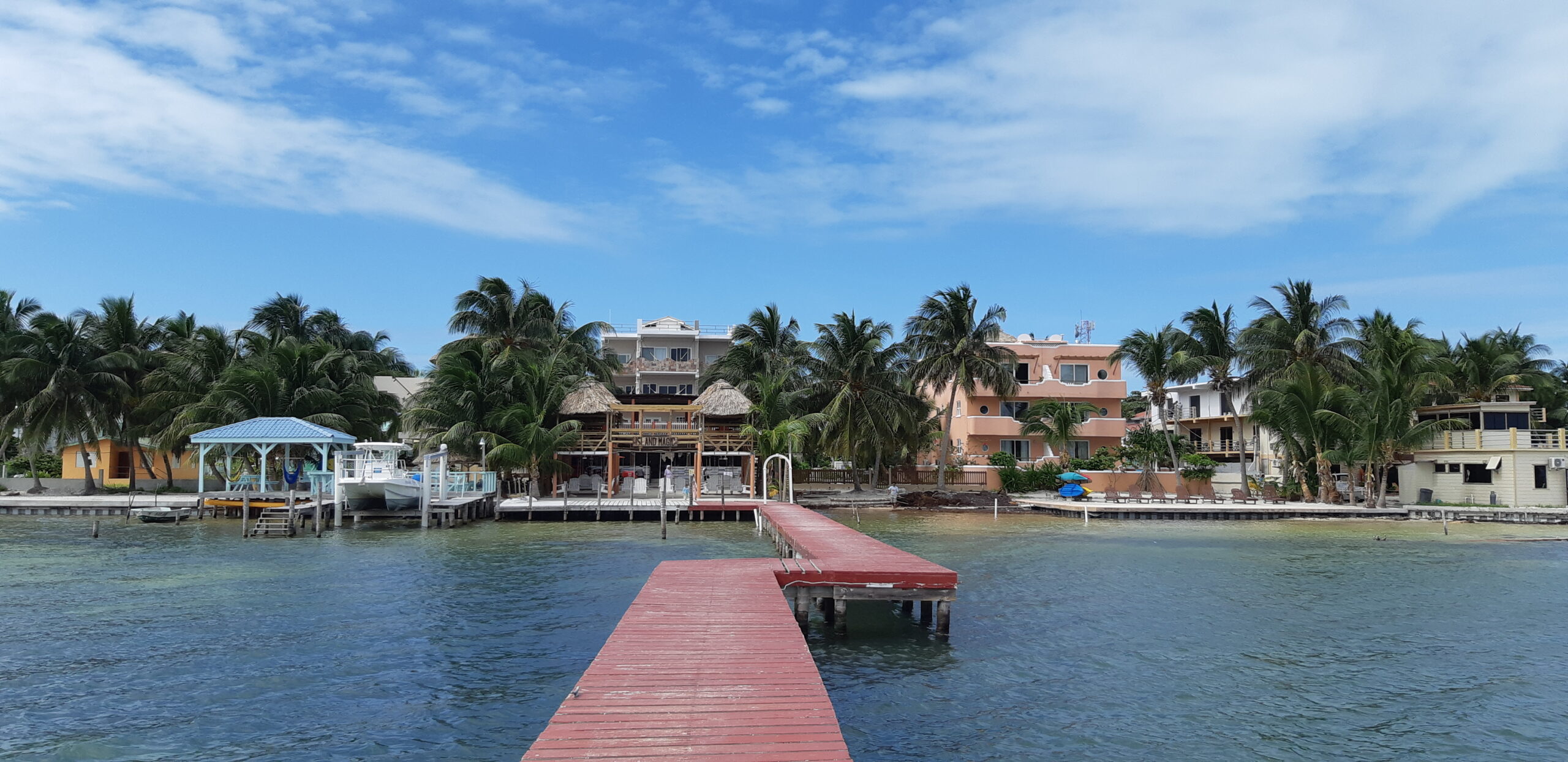 Colourful houses and palms at Caye Caulker island, Belize .